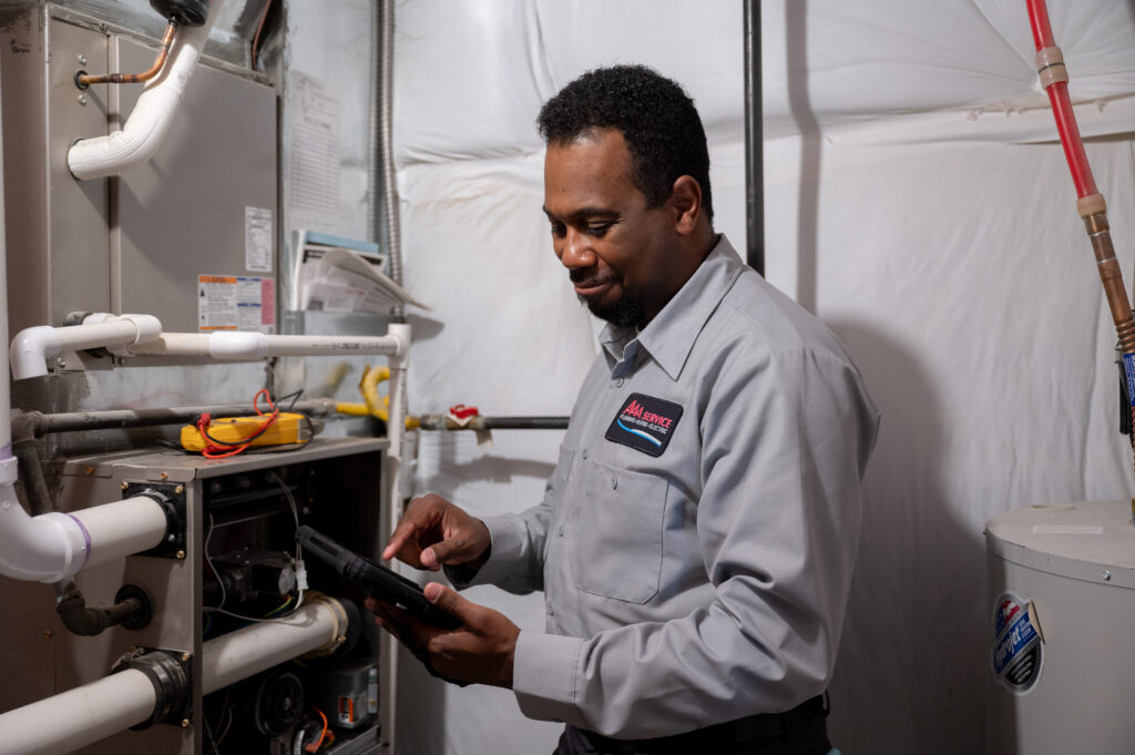 Technician maintaining a home's heating system.